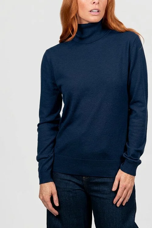 Woman wearing the Ink (dark blue) colour variant of the Bridge & Lord roll neck pullover