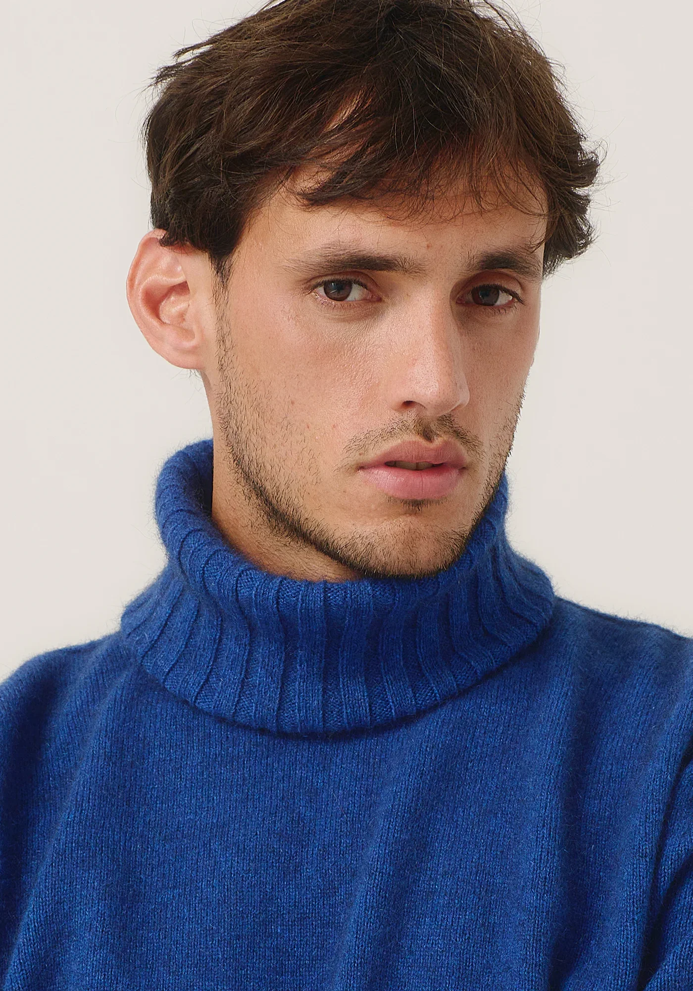 Man wearing the Dusty Blue colour variant of the Merinomink™ Essential Snood — Merino Wool, Possum Fur, Silk
