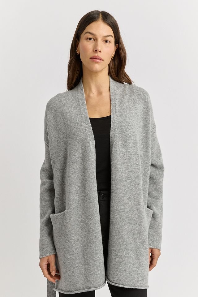 Woman wearing the Light Ash (grey) colour variant of the Toorallie | Relaxed Knit Cardigan  made from 100% Merino lambswool