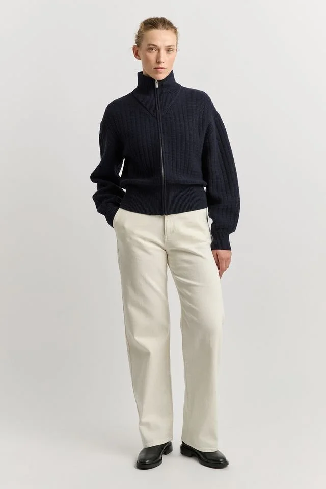 Woman wearing the Toorallie Grid Knit Zip Jacket, navy colour variant.