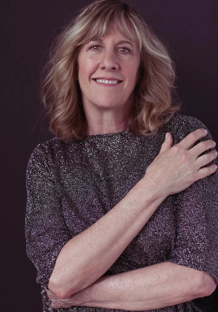 60 year old woman portrait in sparkly top
