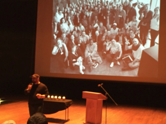 Christian Picciolini with a photo of some of the people who have been rescued from extremist groups worldwide through his non-profit Life After Hate .