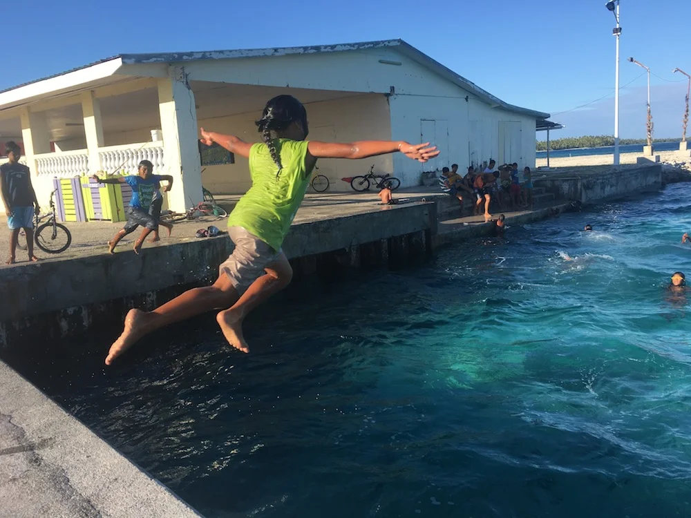 Makemo kids enjoying their normal pastime on the pier in the main village.