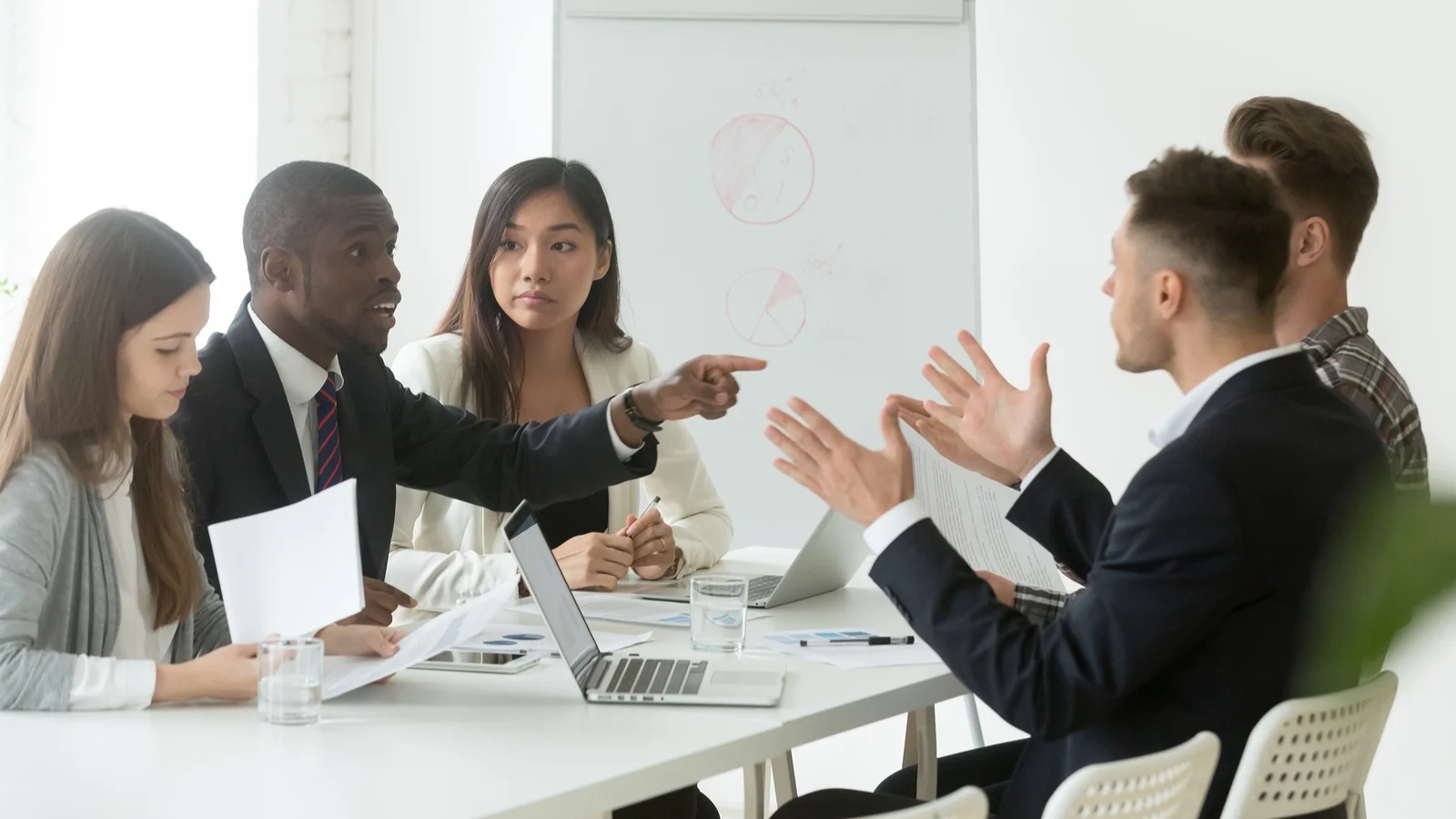 bigstock-Diverse-Employees-Arguing-Duri-240333181.jpg