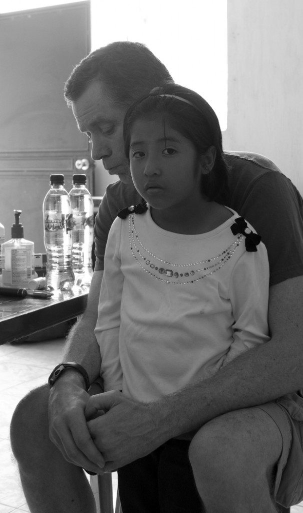 ISMS OpKids Pediatrician John Walsh comforting one of our clinic patients