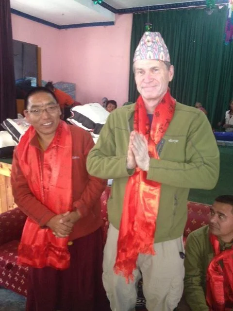 Scott Hamilton, GOS expedition leader, is honored during a community celebration in Marpha, Nepal. The entire team was presented with ceremonial scarves – katas – in thanks for their work.