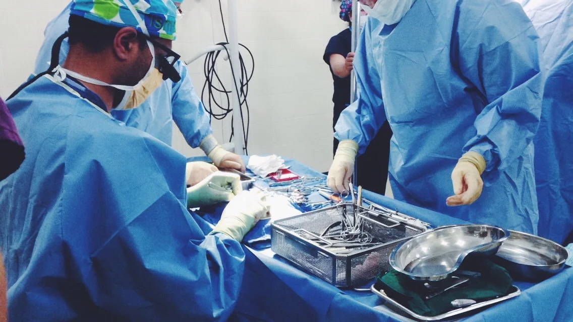 The plastic surgeons perform a Microtia. In this photo, they are carving rib cartilage to form an ear for the patient.