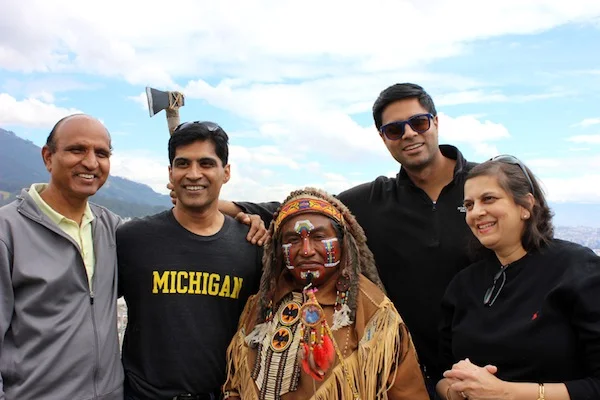 Pradeep, Rita, Brad, and Praveen pose together with man dressed in Inka attire.