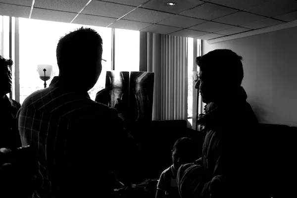 Angel, our contact in Ecuador, translates Mehul’s words to explain an x-ray to the father of a young boy.
