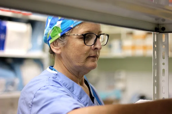 Margrarite unloads various supplies along with the other nurses and CRNAs to get things organized for the week.