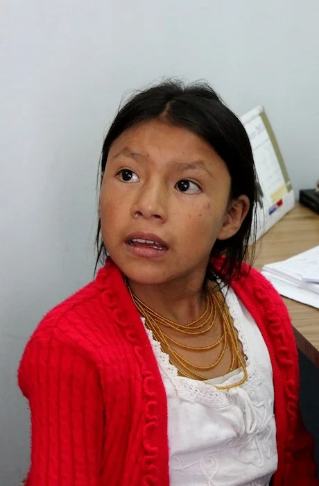 A young patients listens as translators tell the girl and her family the next course of action.