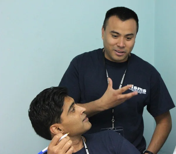 Enrique, our Operation International translator, helps the urologists converse with the local doctor.