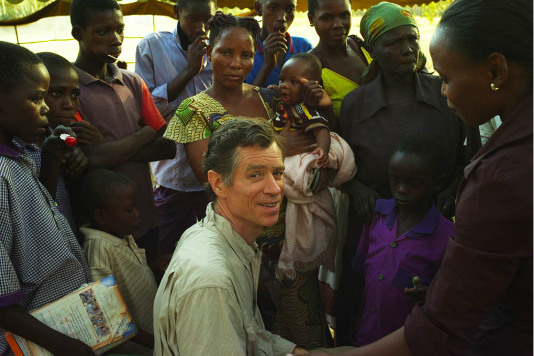 Dr. Walsh surrounded by patients at outdoor clinic