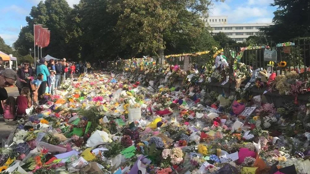 Flowers and cards for the victims of the Christchurch shooting at the Botanic Gardens.