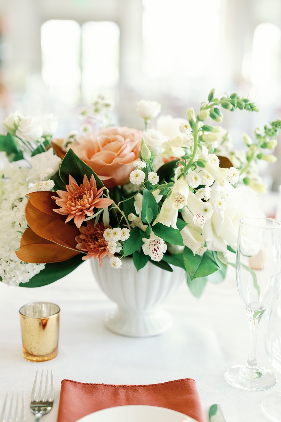 Terracotta wedding flowers in compote