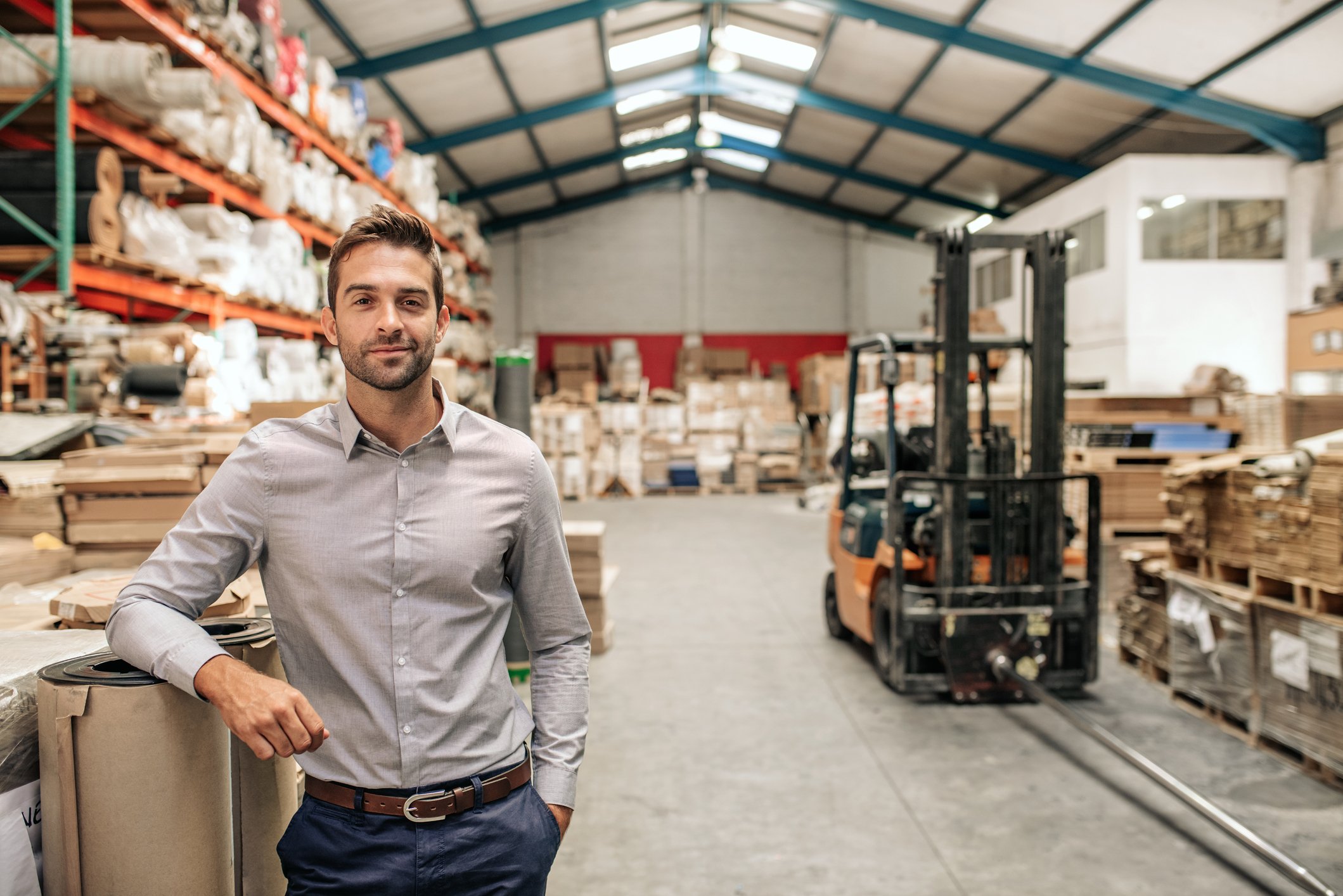 man standing in warehouse looking confident