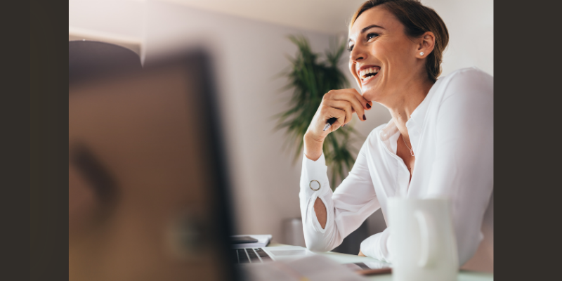 woman at desk smiling