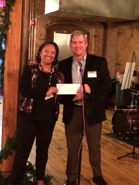 Operation Fuel Acting Director Brenda Watson accepts check from GoodWorks Insurance President Paul Brian.
