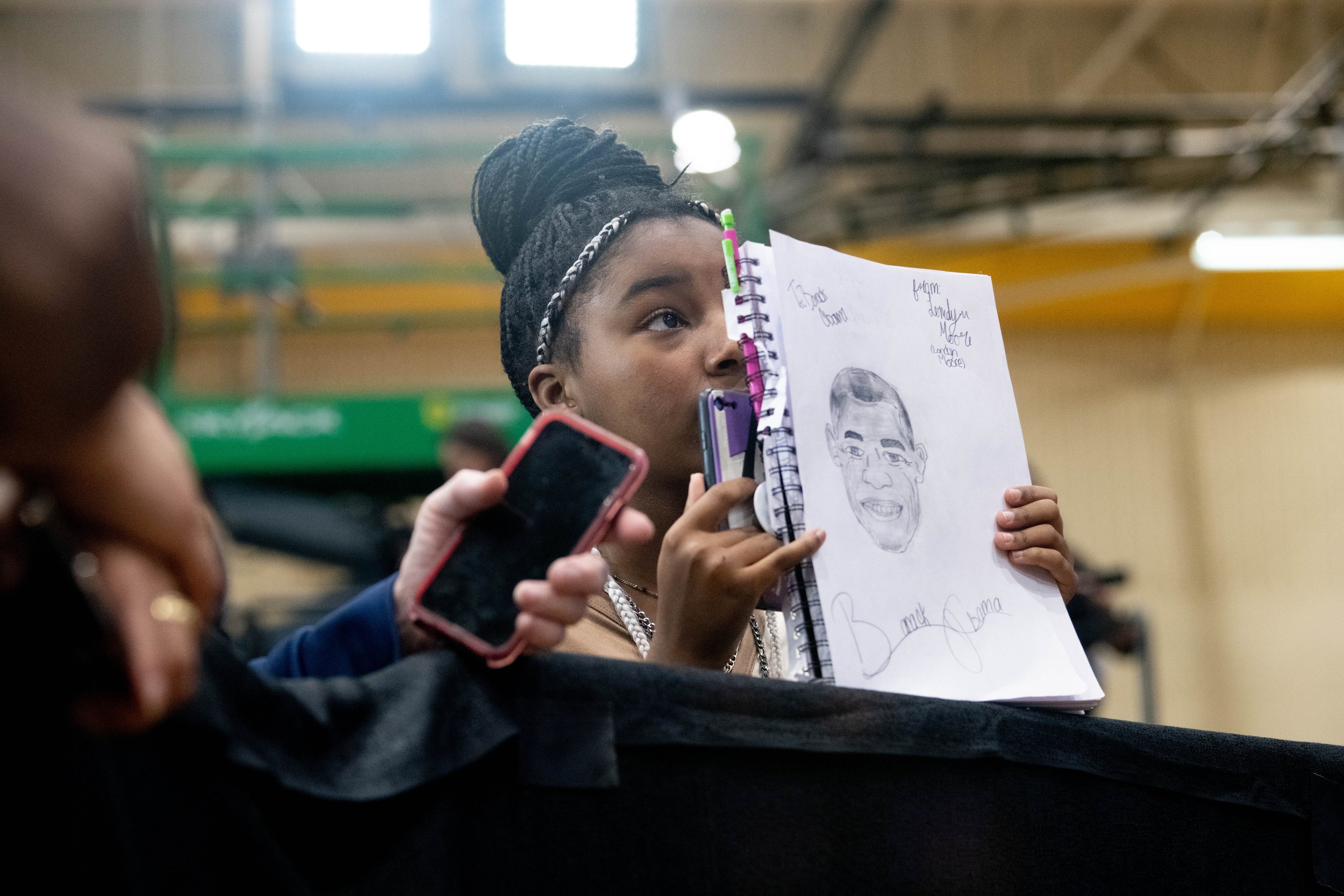 Supporter shows a drawing of President Barack Obama at a campaign event in Wisconsin, 2022