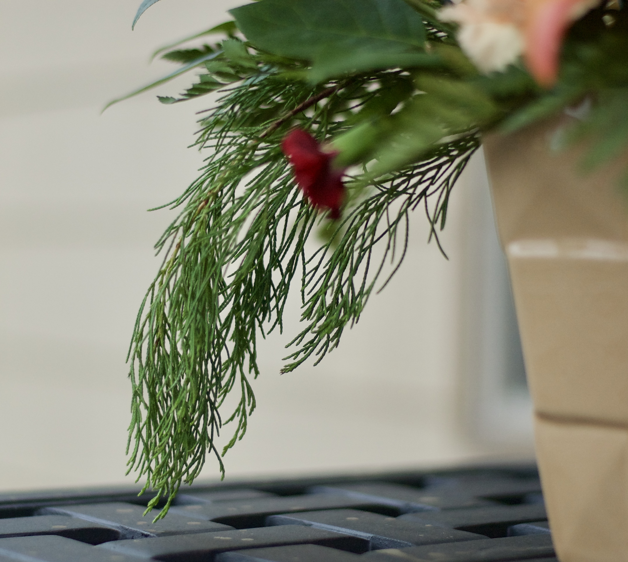 Seasonal greenery draping over an appropriately colored vase