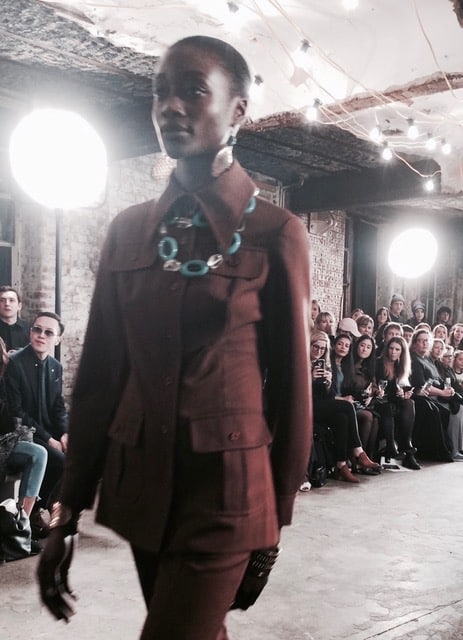 Long collared brown suiting is set off by blue accessories. Picture: Bel Jacobs.
