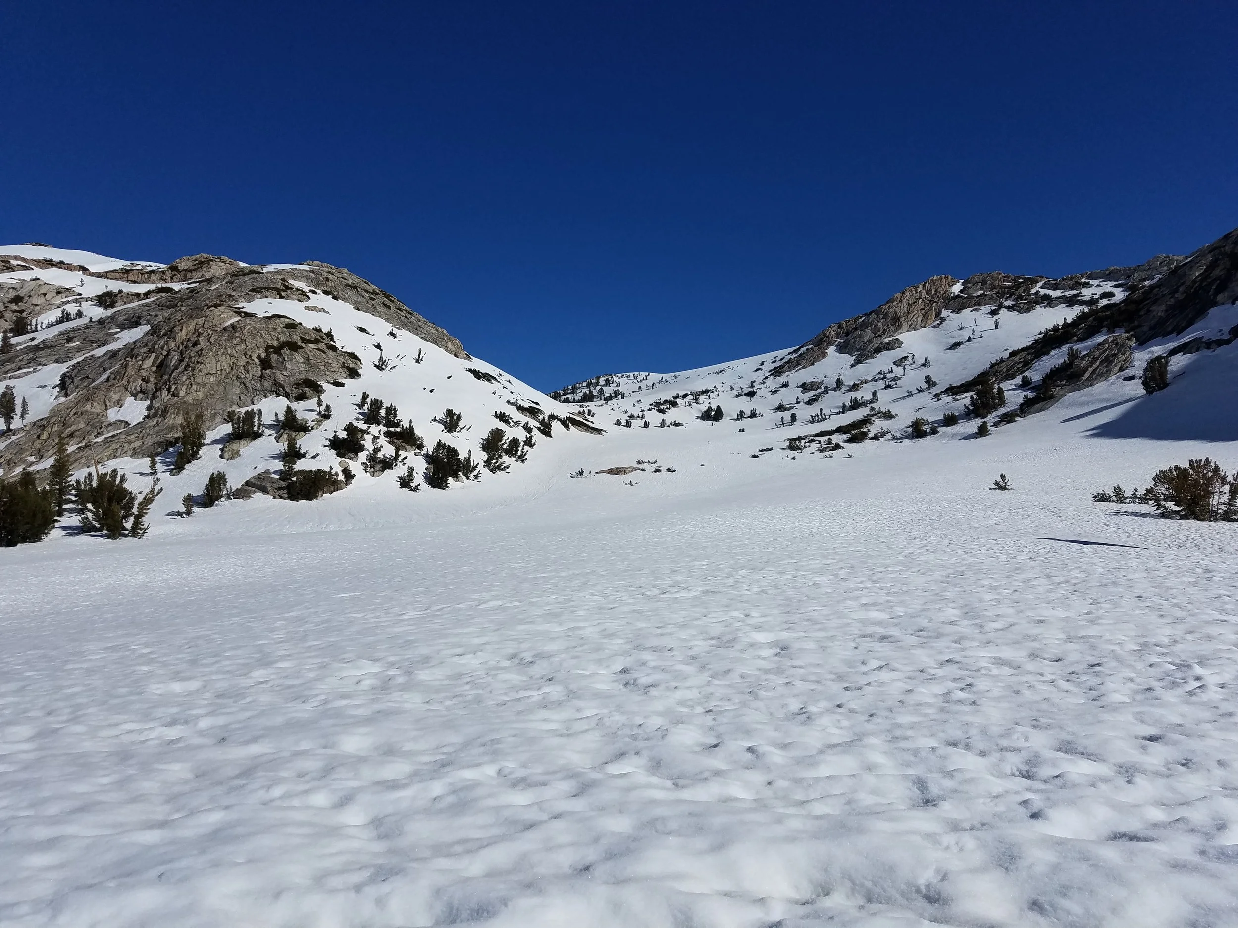 Looking up to Silver Pass, just right of the faint snow/tree mound in the notch.