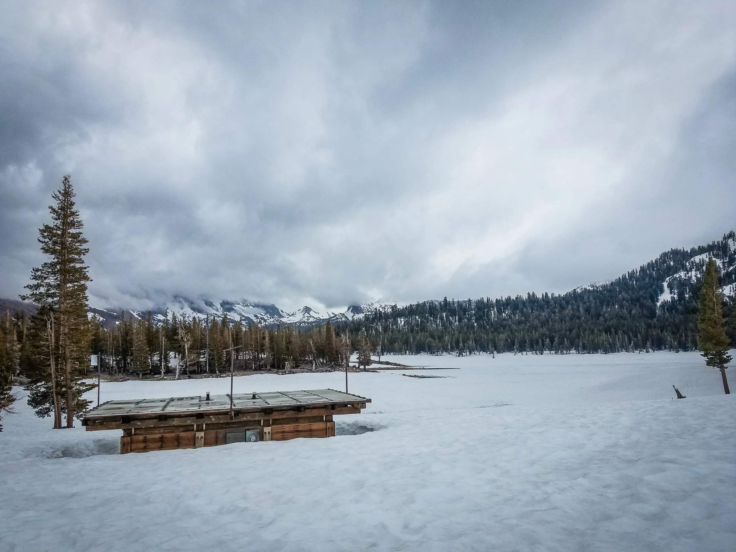 Snowed in pit toilet, Horseshoe Lake in the background. This area is usually snow-free and open by the third week in May...