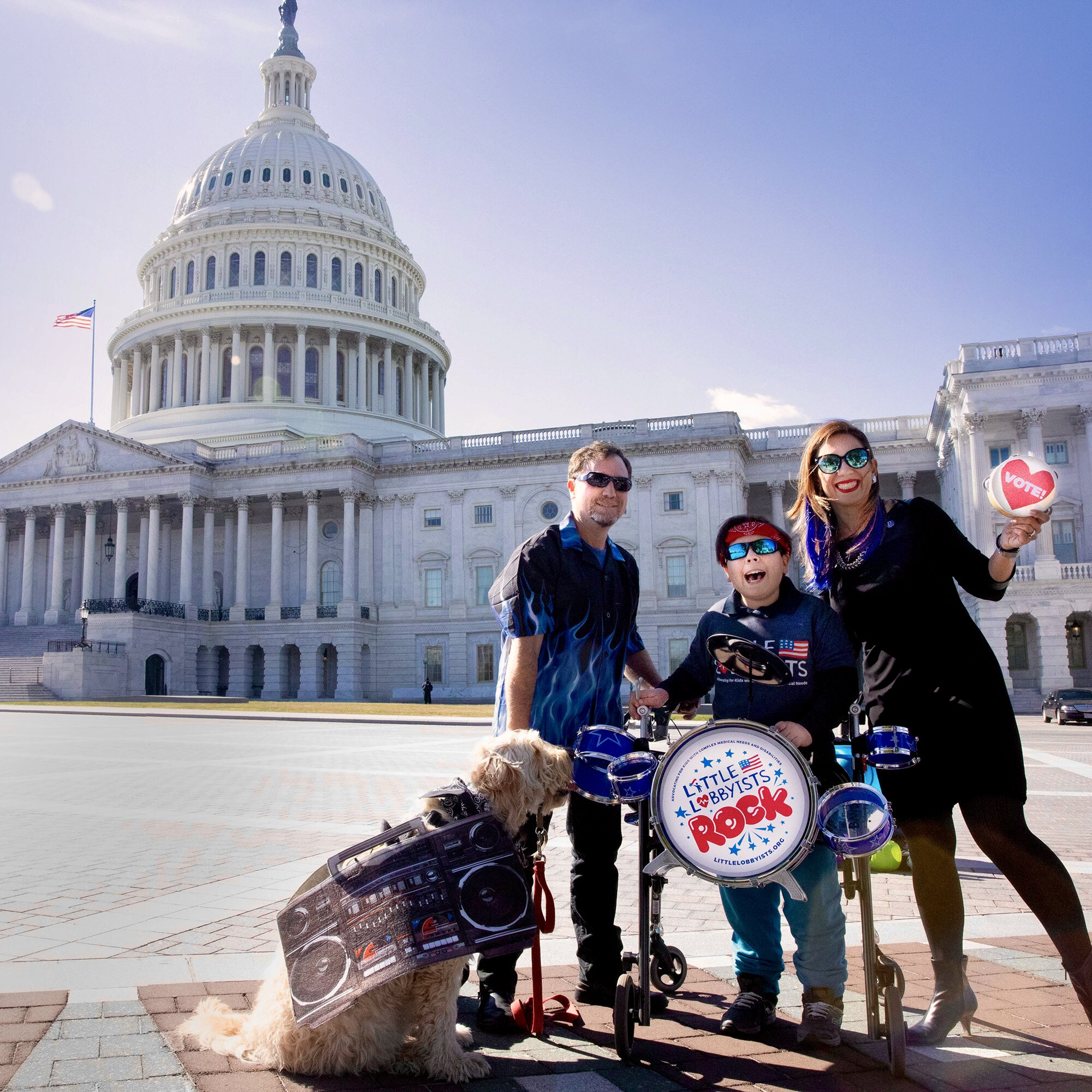  A Little Lobbyists family poses in front of the U.S. Capitol, accompanied by a dog and a drum set. 