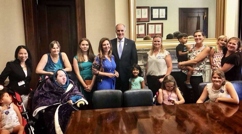  A group of Little Lobbyists families pose with a U.S. Senator after a meeting on health care. 