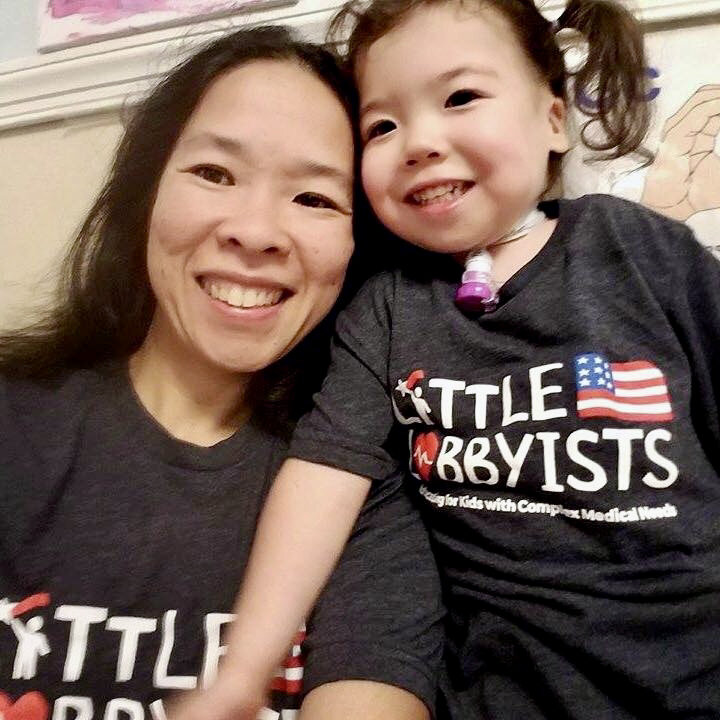  A founder of Little Lobbyists poses with her daughter. Both wear navy blue t-shirts with the LL logo. 