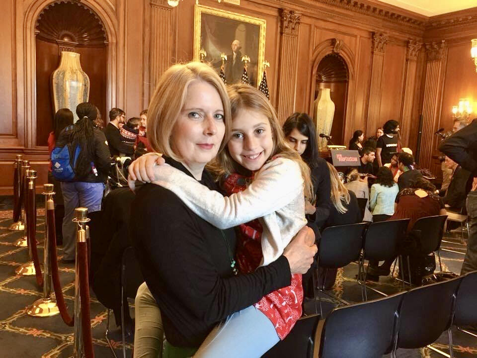  A mom and her daughter pose after a press conference in the U.S. Capitol. 