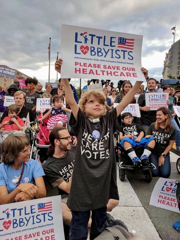  A young boy holds up a Little Lobbyist sign at a rally on Capitol Hill. 