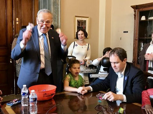  The then-U.S. Senate Minority Leader distributes Halloween candy to a group of children in his office. 