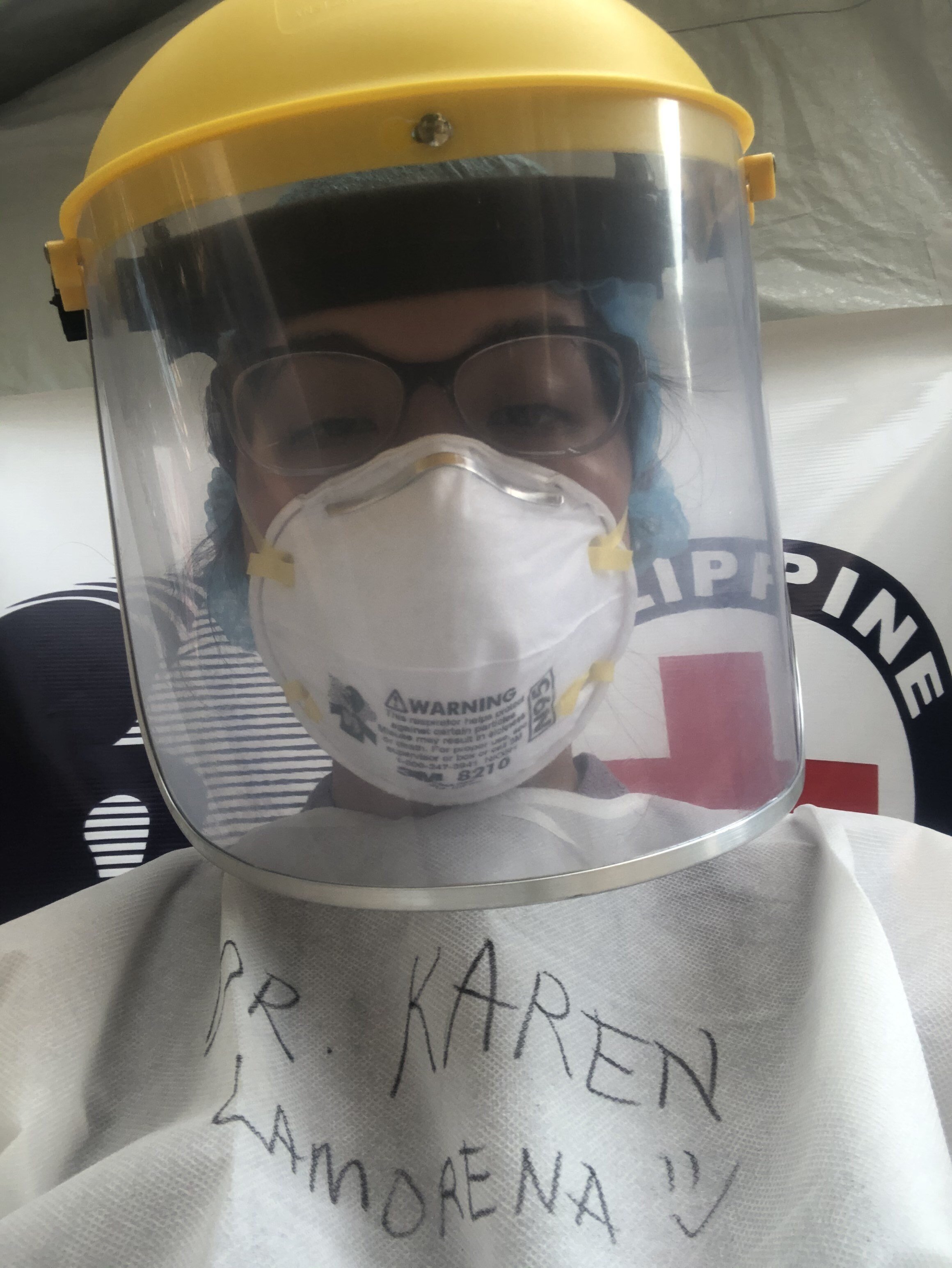 In her PPE.