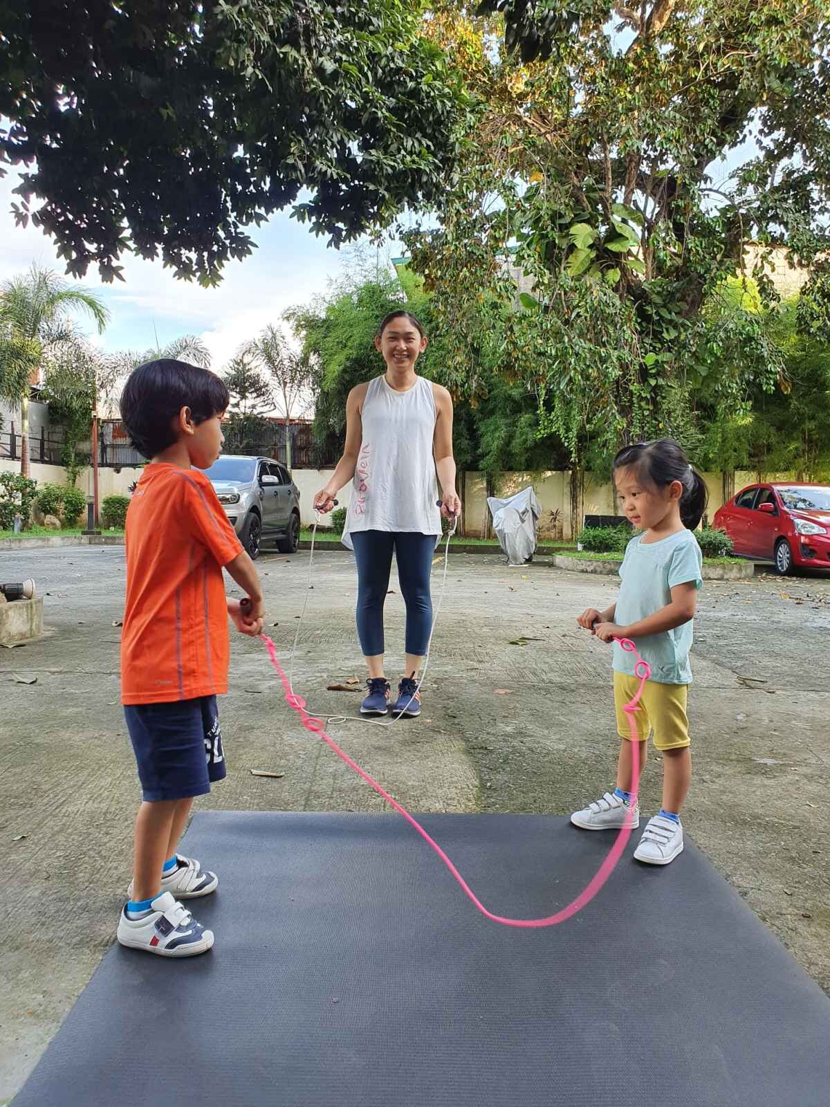 Angela jump roping with her two older kids.