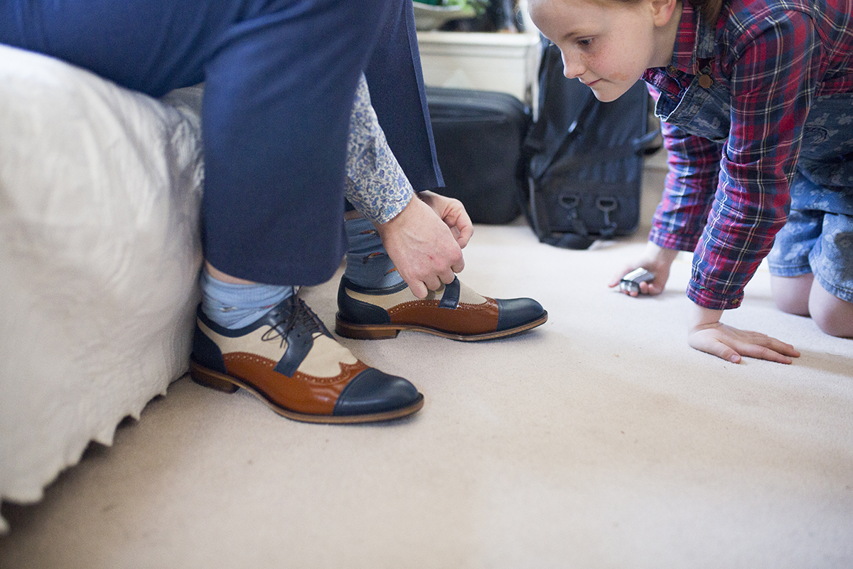 groom tying his shoelaces