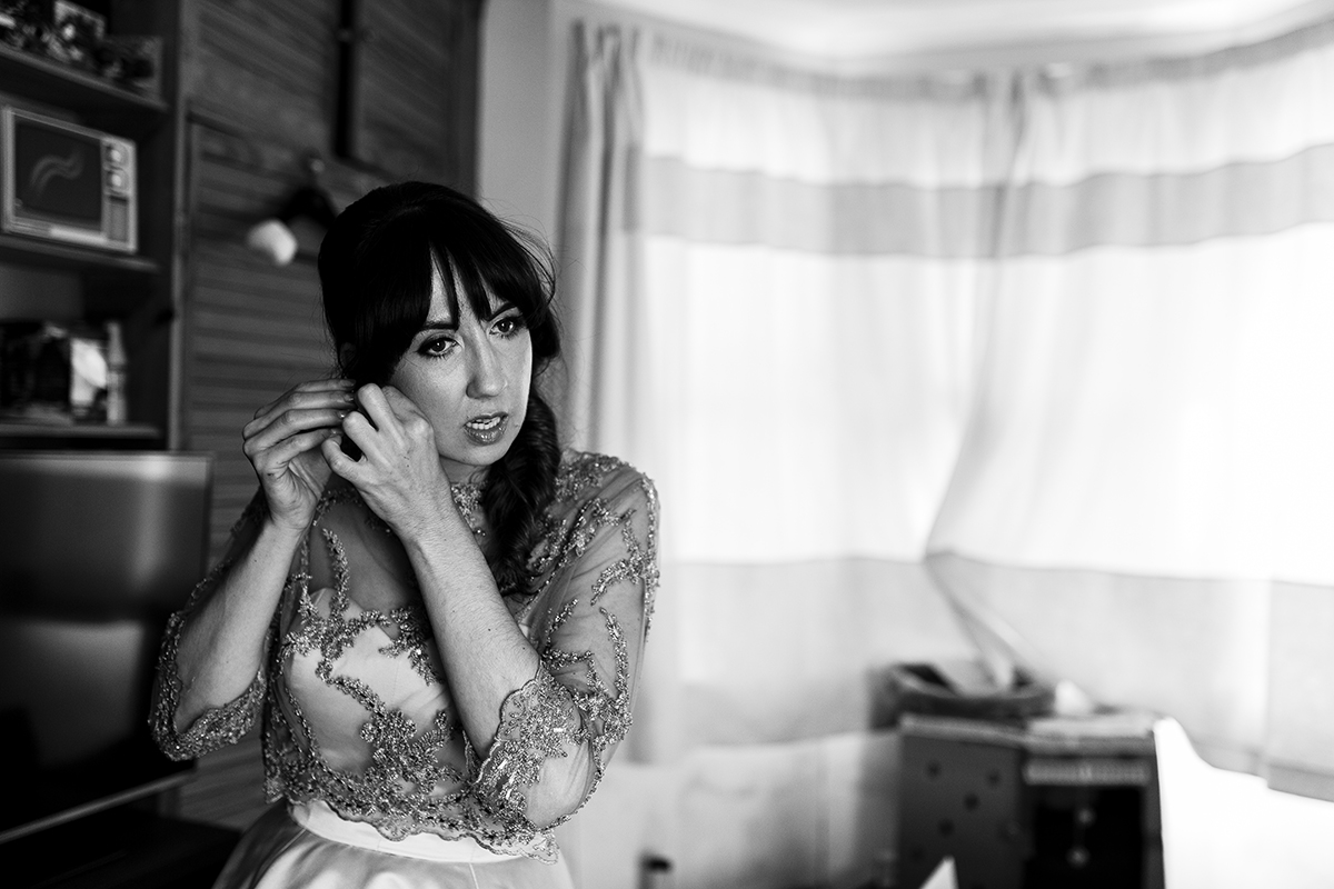 Bride putting on her earrings Sophie Lake Wedding Photography