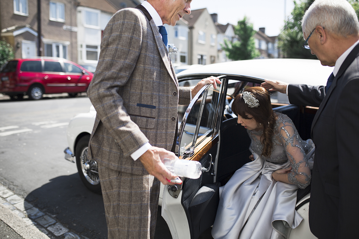 Bride getting in the car Sophie Lake Photography