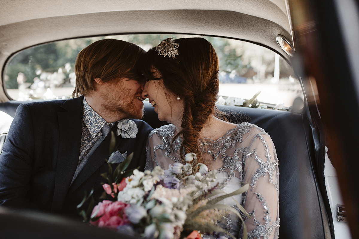 Bride and Groom in wedding car Sophie Lake Photography