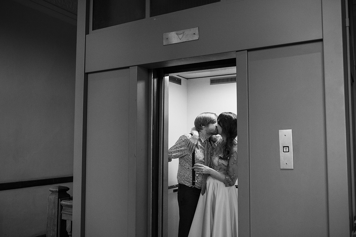 Bride and Groom kissing in lift Sophie Lake Photography