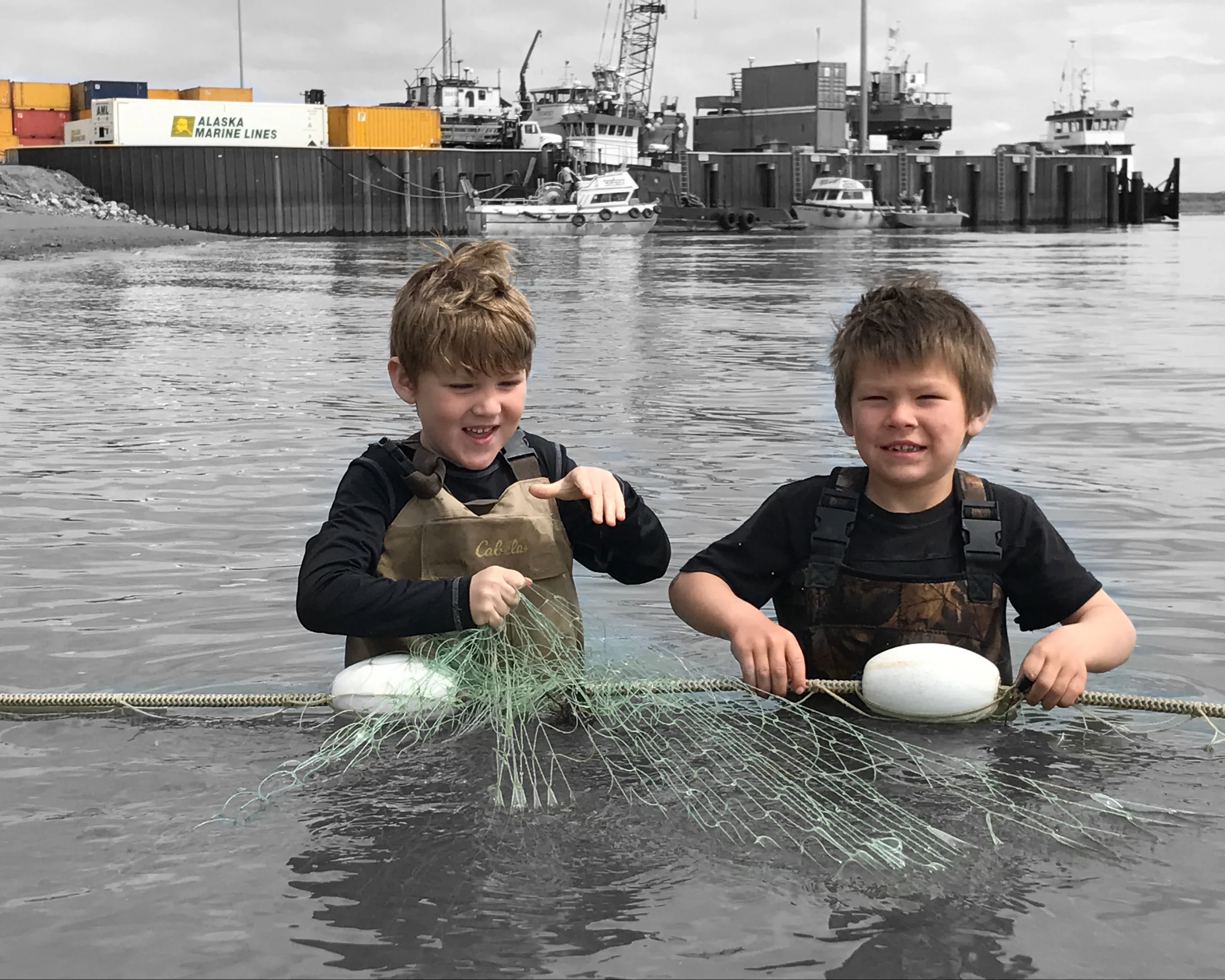 Victor Thompson and Name Savo picking their families subsistence fishing net near the Port of Bristol Bay on the Naknek River.