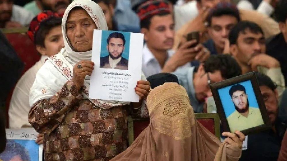 Women hold images of their loved ones who have gone missing during the conflict in Northwest Pakistan. One of PTM’s demands is that “missing persons” be presented in the courts and be granted the right to a fair trial. Image: France 24
