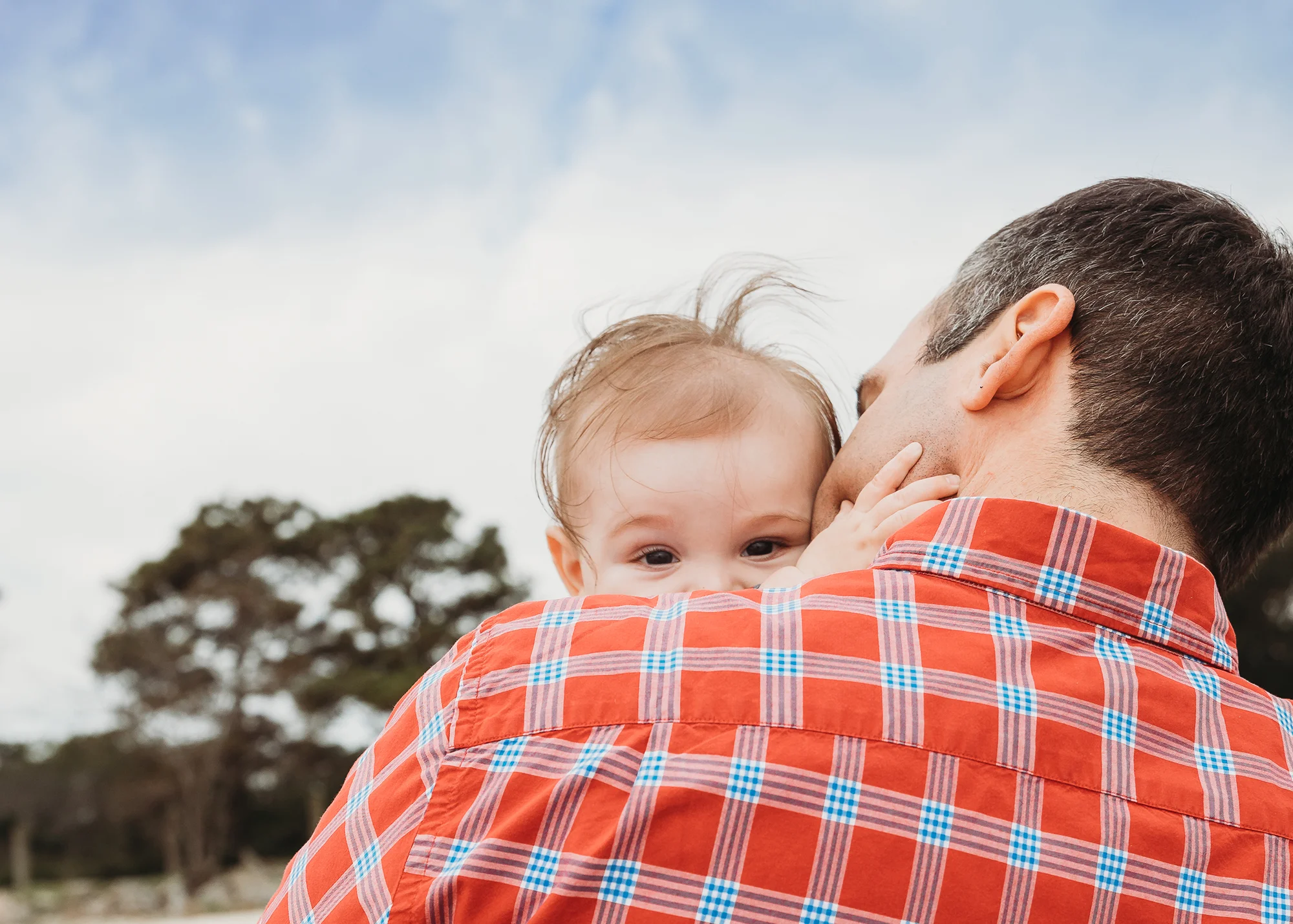 Dad and baby son with wild hair on the beach. Boston family photographer. Baby photos Massachusetts.