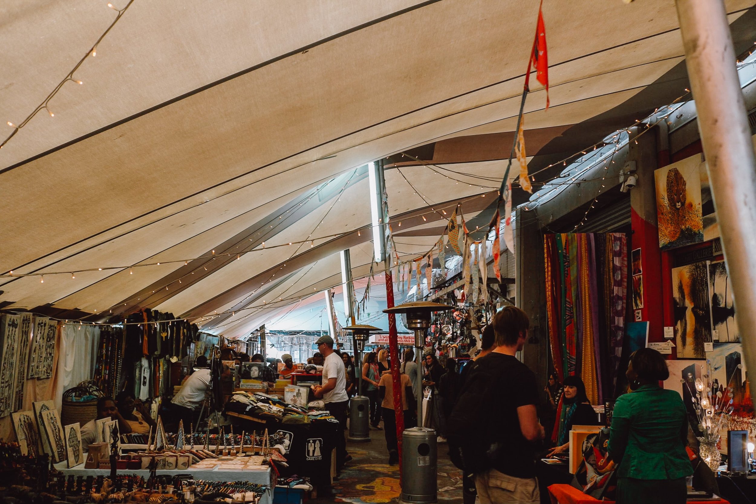 Inside covered market at Hout Bay Market with local sellers