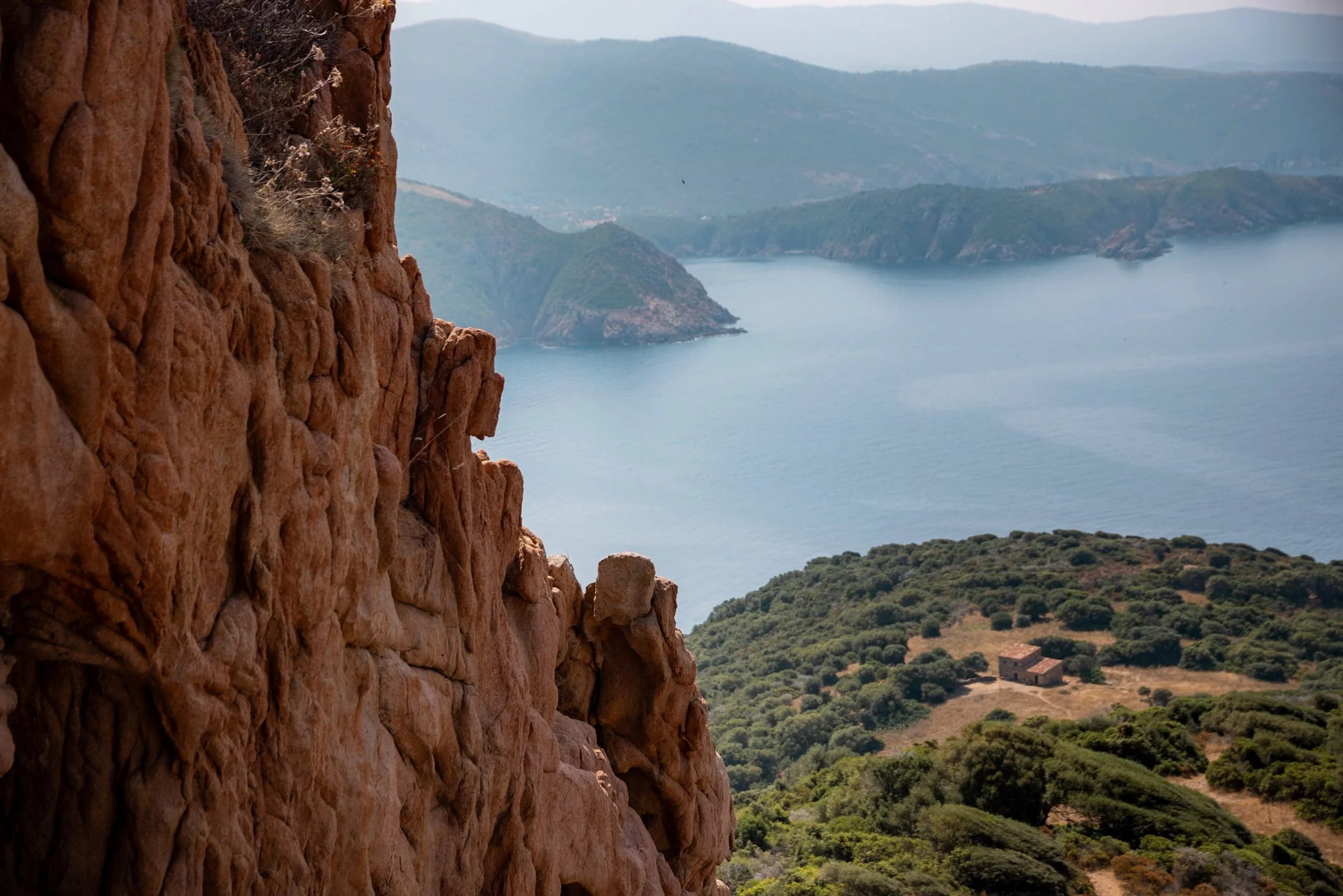 capo-rosso-pink-rocks-contrast with coastal views