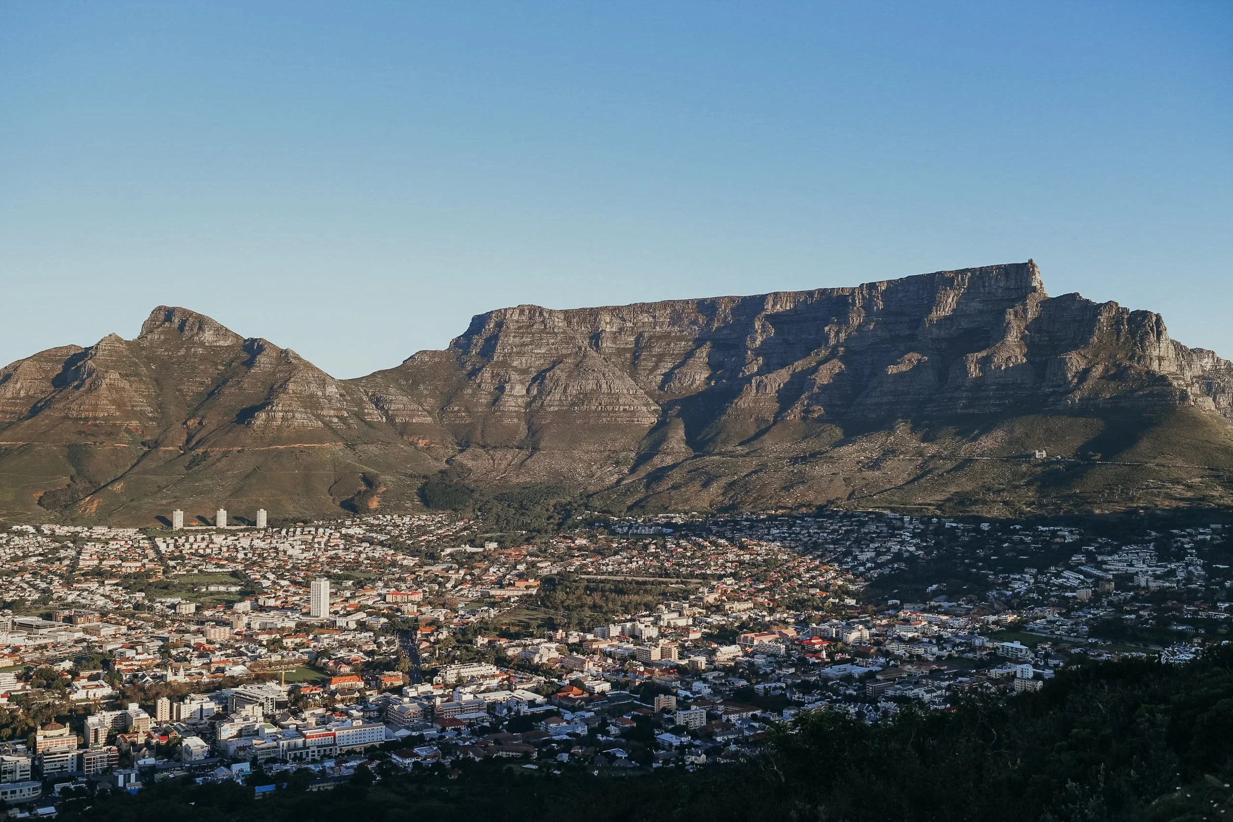 Table mountain on a clear blue sky sunny day with cape town below