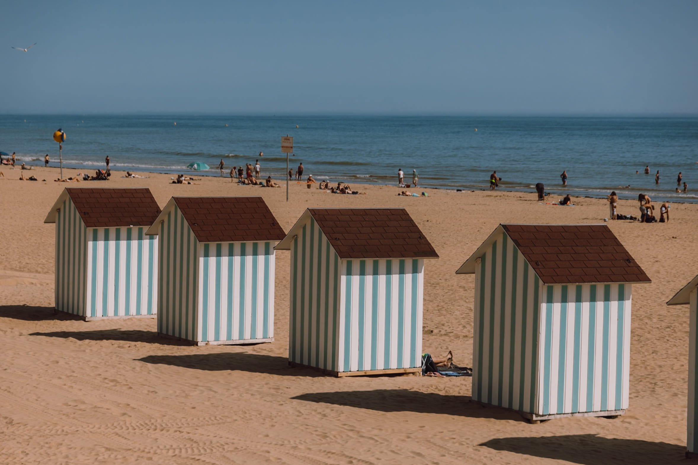 Blue striped beach huts on beach in Saint Jean de Monts