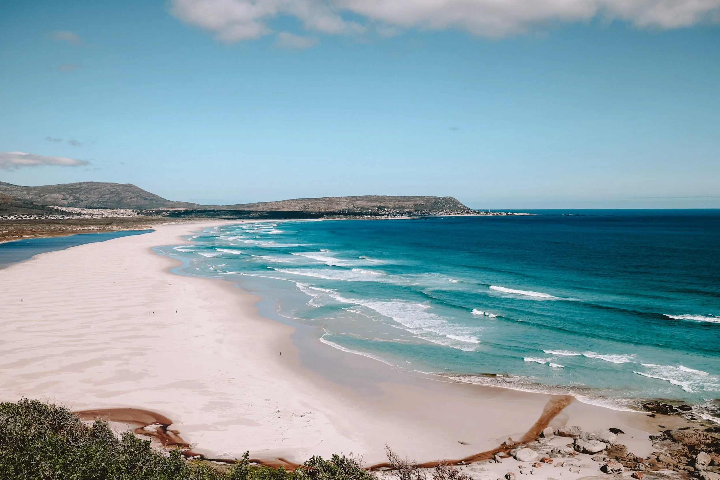 beginning of chapmans peak drive big large sandy stretch of white sand and bright turquoise water