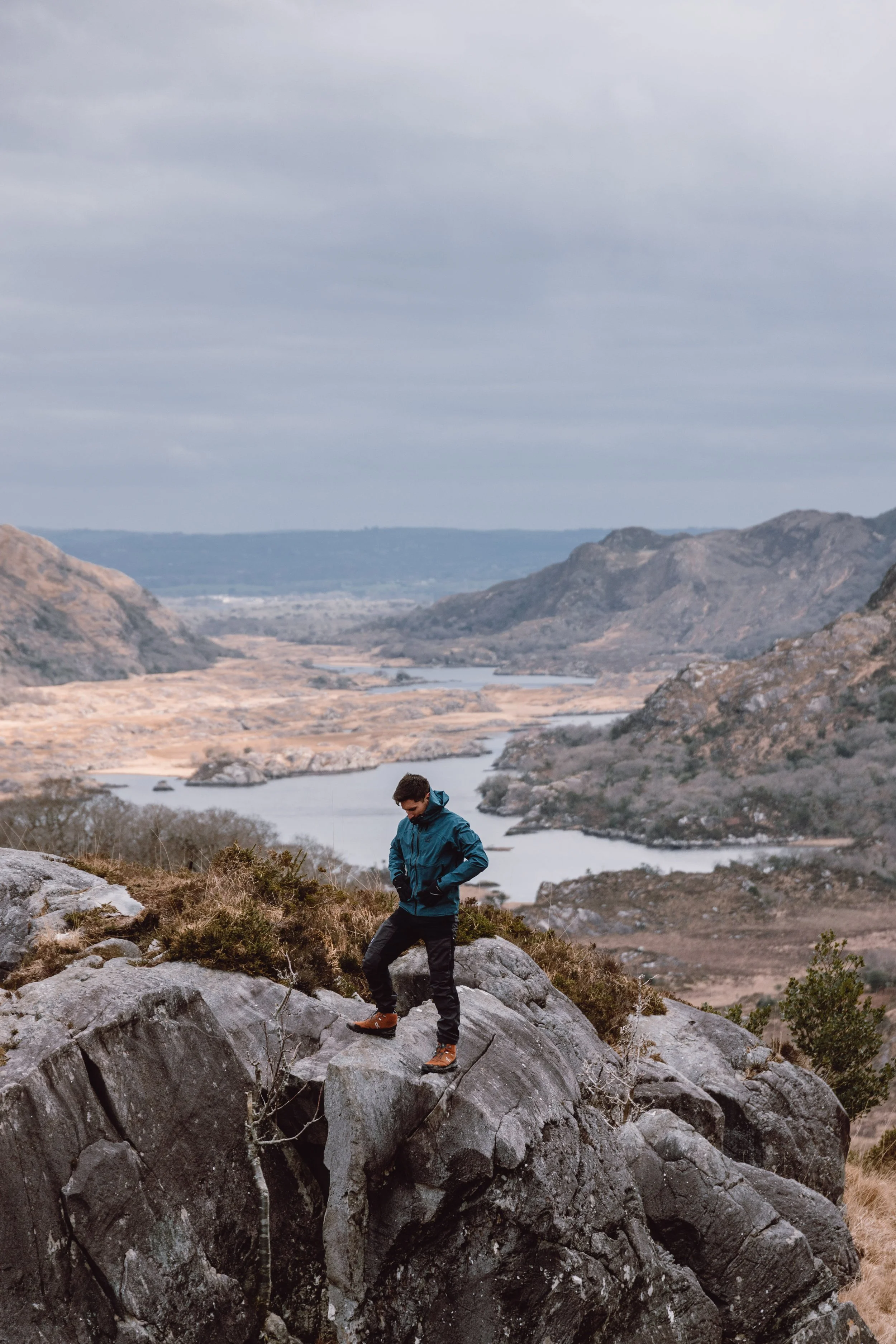 Man standing on rocks infront of the lakes atKillarney National Park