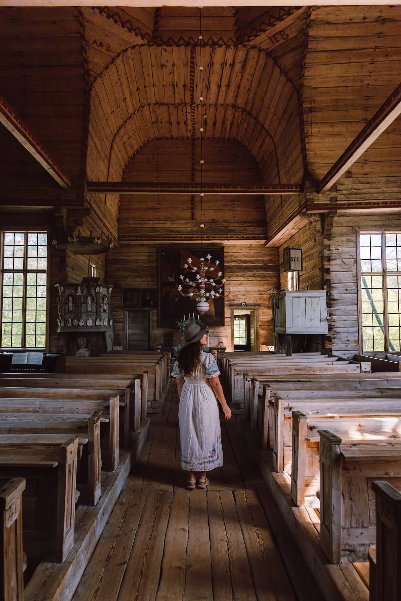 woman standing in old wooden church in Petajavesi
